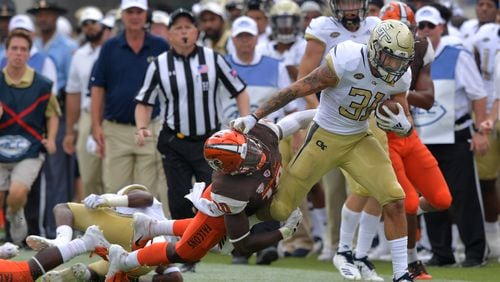 Georgia Tech running back Nathan Cottrell (31) eludes a tackle by Bowling Green defensive back Torrian Hampton (10) from in the second half at Bobby Dodd Stadium on Saturday, September 29, 2018.  HYOSUB SHIN / HSHIN@AJC.COM