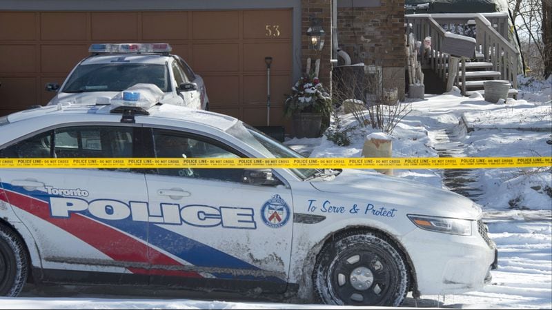 Toronto police cars are pictured Tuesday, Jan. 30, 2018, in front of a house on Mallory Crescent in the city. Investigators have discovered remains from at least six people in planters outside the home, where landscaper and suspected serial killer Bruce McArthur is believed to have buried them. McArthur, who is charged with killing at least five men, was allowed to store his landscaping equipment at the home in exchange for mowing and tending to the owners' lawn.