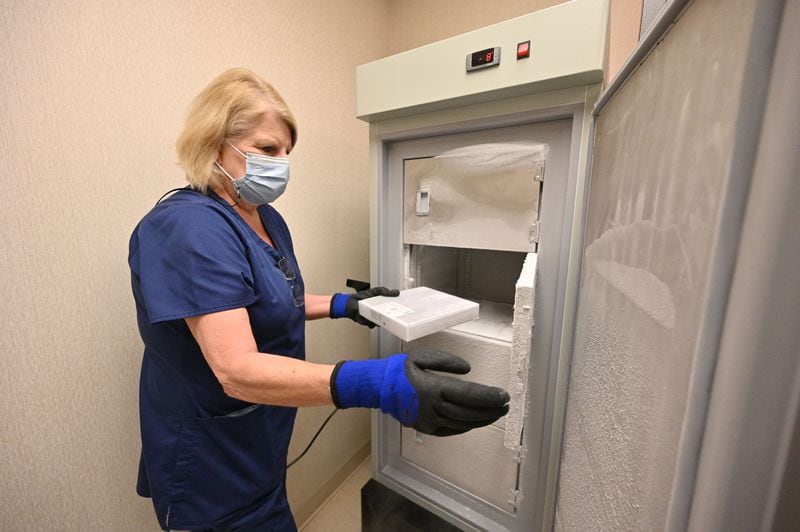 Tina Mewborne, LPN, opens a freezer containing the Pfizer-BioNTech COVID-19 vaccine at the Medical Center of Elberton on Wednesday, January 27, 2021. (Hyosub Shin / Hyosub.Shin@ajc.com)