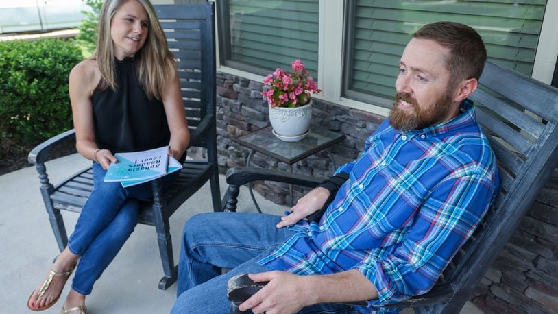 Anna & Ryan Teal on the front porch of their Canton home. Ryan suffered a stroke that left him with Aphasia. He & Anna have developed adult readers to help people with this strengthen their communication skills. PHIL SKINNER FOR THE ATLANTA JOURNAL-CONSTITUTION.