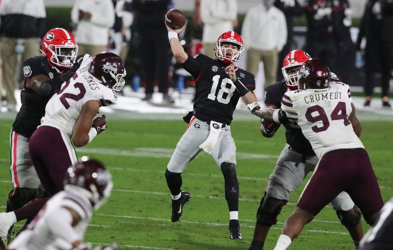 Bulldogs quarterback JT Daniels (18) throws to wide receiver Jermaine Burton (7) for a first down in the second quarter against the Mississippi State Bulldogs Saturday, Nov. 21, 2020 at Sanford Stadium in Athens.    (Curtis Compton/Curtis.Compton@ajc.com)  