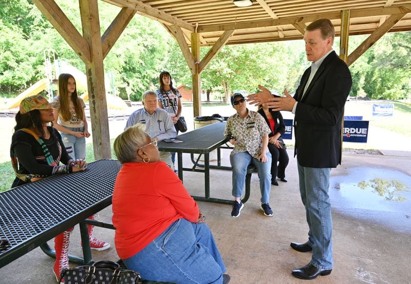 Former U.S. Sen. David Perdue, shown speaking to voters in May 2022 at Sell's Mill Park in Hoschton, never embraced the day-to-day grind of the campaign trail. But Perdue could emerge as a key surrogate for former President Donald Trump during this year's presidential campaign. (Hyosub Shin / Hyosub.Shin@ajc.com)