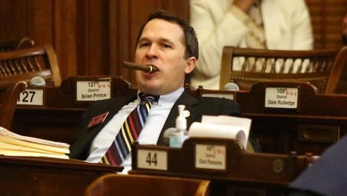 4/2/19 - Atlanta-  Representative Matt Dollar, district 45, holds a cigar in his mouth while a bill is being presented at the Georgia State Capitol in Atlanta, Georgia on Tuesday, April 2, 2019. Today is sine die day, the final day of the 2019 legislature. EMILY HANEY / emily.haney@ajc.com
