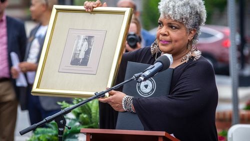Family member Inger Williams holds up a photograph of Willie Williams, the wife of Charles Hale, during the soil collection ceremony in Lawrenceville on Juneteenth, Saturday 19, 2021, in memory of Hale's 1911 lynching. Soil from the lynching site will be housed at the Legacy Museum, near the National Memorial for Peace and Justice in Montgomery, Alabama. (Photo: Steve Schaefer for The Atlanta Journal-Constitution) AJC FILE PHOTO