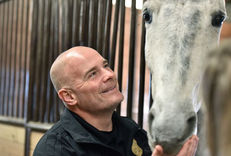  Lt. Greg Lyon checks on patrol horse Cody at Atlanta Police Department mounted patrol unit stables on January 8, 2020. Each APD horse is a sworn officer with its own badge. (Hyosub Shin / Hyosub.Shin@ajc.com)