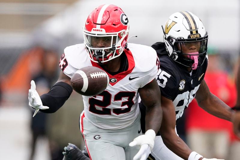 Georgia defensive back Tykee Smith (23) makes an interception against Vanderbilt wide receiver Junior Sherrill, right, in the first half of an NCAA college football game Saturday, Oct. 14, 2023, in Nashville, Tenn. (AP Photo/George Walker IV)
