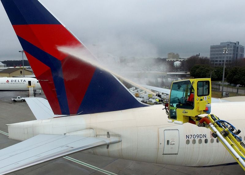 A Delta worker demonstrates the deicing process. 