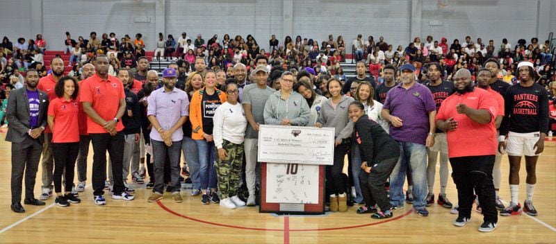 Tina Taylor Brown, surrounded by her children, family and friends presents the Clark Atlanta University Basketball program with a $150,000 check, in honor of NBA referee Tony Brown from the Tony and Tina Brown Scholarship Endowment. The presentation occurred during the first game of the season on Nov. 7, 2022.
