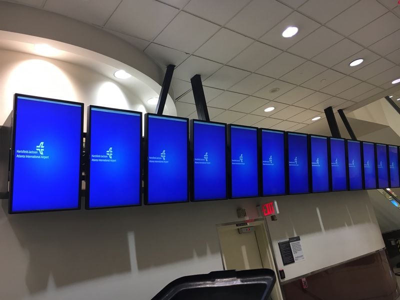 Screens that typically show the status of incoming and outgoing flights at Hartsfield-Jackson International Airport were blank early Monday. BEN BRASCH / BEN.BRASCH@COXINC.COM