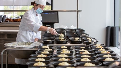 Arielle Grant helps prepare 250 shepherd’s pies in the kitchen at the Mercedes-Benz USA headquarters in Sandy Springs for a Second Helpings Atlanta delivery. PHIL SKINNER FOR THE ATLANTA JOURNAL-CONSTITUTION.