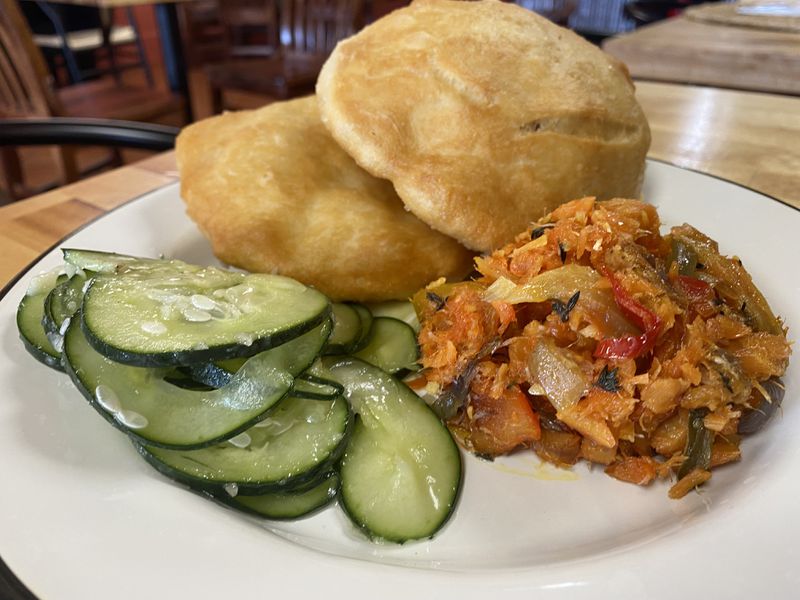 The Saint Lucia breakfast includes salt fish and pastries, along with pickled cucumbers.  Ligaya Figueres/ligaya.figueras@ajc.com