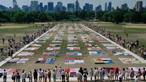 In 1988, people watch as almost 1,500 quilt panels bearing the names of New York area residents who died of AIDS are unfolded on the Great Lawn in New York’s Central Park. Author Jeff Graham says society’s early treatment of the HIV/AIDS crisis carries lessons for us today in the era of the coronavirus pandemic. (AP Photo/Wilbur Funches, File)
