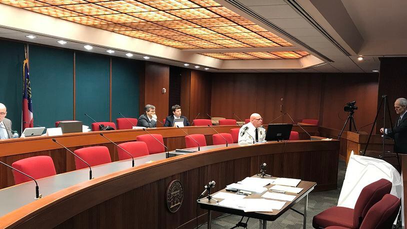 Decatur City Attorney Bryan Downs, at the podium, appeared before the Georgia Immigration Enforcement Review Board in May 2018 with Police Chief Mike Booker, seated to his right, and defended the city against a complaint filed by Lt. Gov. Casey Cagle.