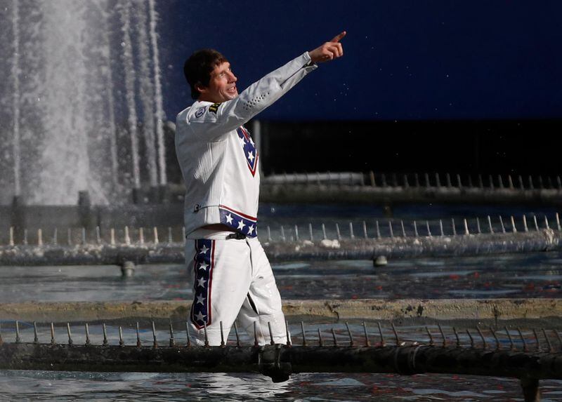 Travis Pastrana celebrates in the fountain at Caesars Palace after jumping it on a motorcycle Sunday, July 8, 2018, in Las Vegas. Pastrana recreated three of Evel Knievel's iconic motorcycle jumps on Sunday, including the leap over the fountains of Caesars Palace that left Knievel with multiple fractures and a severe concussion.