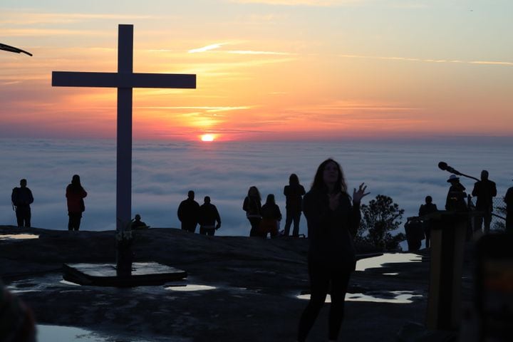 Crowds gather as the sun rises on top of Stone Mountain during the 76th annual Easter Sunrise Service on Sunday, April 17, 2022. The popular event returned to the park after a two-year hiatus because of the pandemic on Sunday, April 17, 2022. Miguel Martinez/miguel.martinezjimenez@ajc.com
