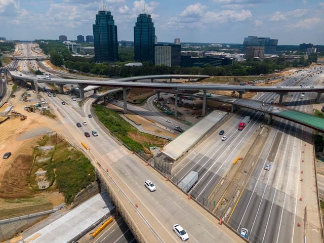 May 27, 2021 Sandy Springs - Aerial photo shows construction site of I-285 interchange at Ga. 400 in Sandy Springs on Tuesday, May 27, 2021. The view is looking north on Georgia 400 and east on I-285 (in foreground) with the King and Queen buildings in the distance. (Hyosub Shin / Hyosub.Shin@ajc.com)