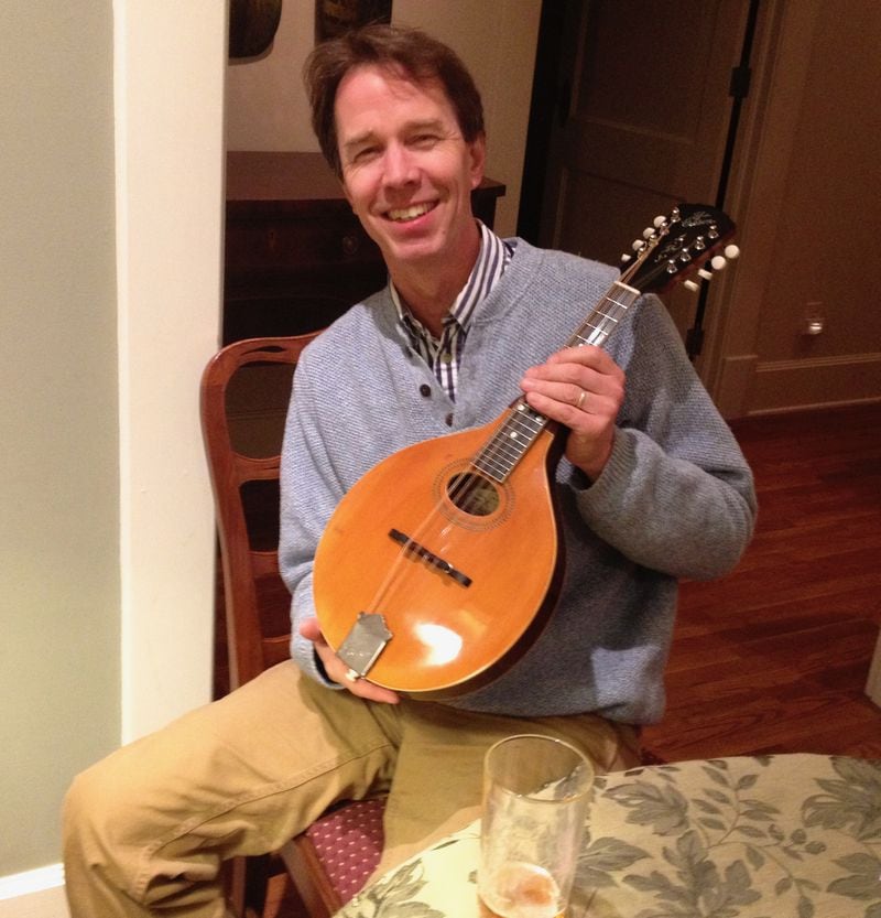 A happy customer with a repaired mandolin. Photo: Jack Brantley