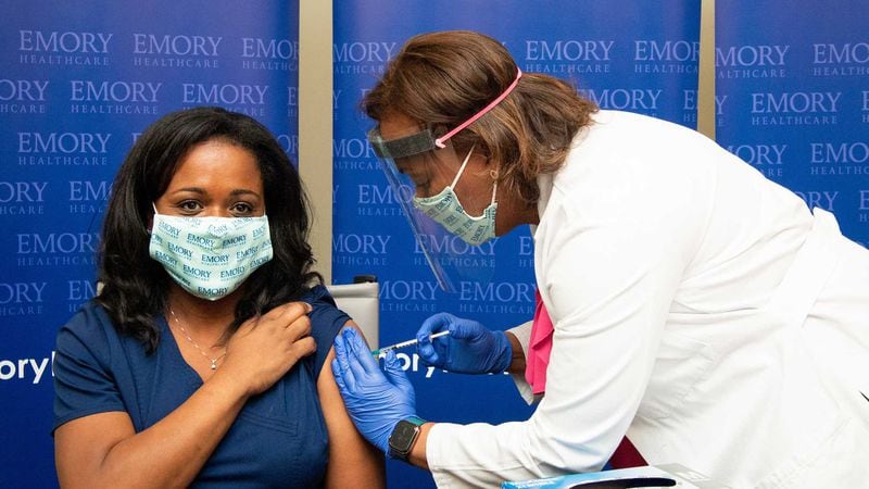 Nicole Baker, left, an emergency room nurse and manager at Emory University Hospital, was the first employee to receive the Pfizer-BioNTech vaccination at Emory last December. CONTRIBUTED.
