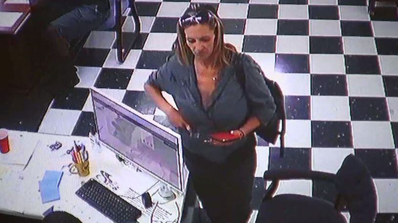A woman seen on surveillance video is suspected of stealing a minivan from a Hall County dealership. (Credit: Kar Kingdom)
