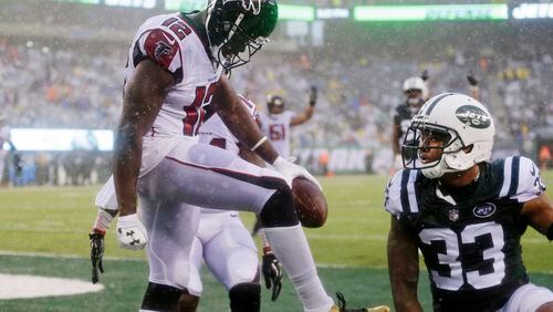 Atlanta Falcons wide receiver Mohamed Sanu (12) celebrates after catching a pass for a touchdown as New York Jets strong safety Jamal Adams (33) reacts during the second half of an NFL football game Sunday, Oct. 29, 2017, in East Rutherford, N.J. (AP Photo/Seth Wenig)