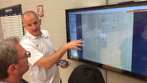 Georgia Tech assistant coach Eric Reveno demonstrates the team's new shot-tracking system, which was developed in part by a NASA scientist.