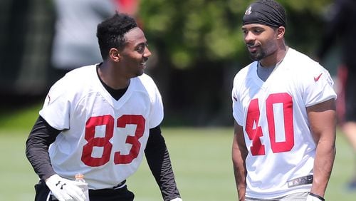 Falcons wide receiver Russell Gage (left) shares a laugh with safety Tere Calloway after the first day of rookie minicamp on Friday, May 11, 2018, in Flowery Branch.  Curtis Compton/ccompton@ajc.com