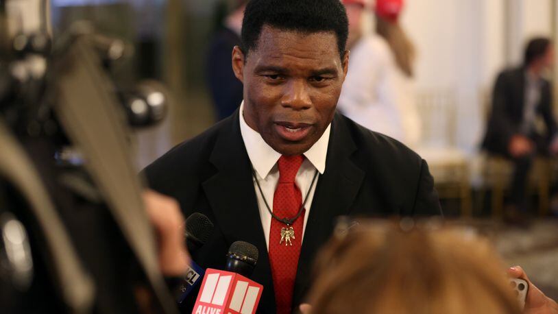 Herschel Walker speaks to members of the media Tuesday after his primary win to gain the GOP nomination to the U.S. Senate. Asked whether there should be new gun laws in the wake of a mass shooting earlier that day at a Texas elementary school, Walker said, “What I like to do is see it and everything and stuff.” (Jason Getz / Jason.Getz@ajc.com)