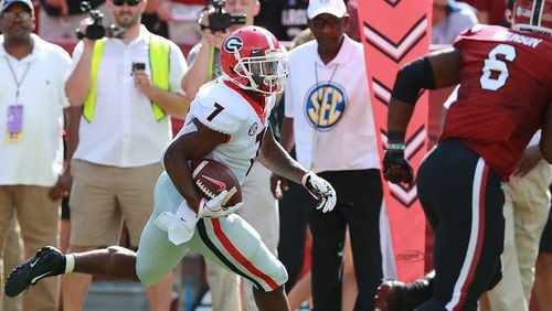 Georgia running back D'Andre Swift breaks away from South Carolina defender T.J. Brunson for a touchdown Saturday, Sept 8, 2018, in Columbia. Curtis Compton / ccompton@ajc.com