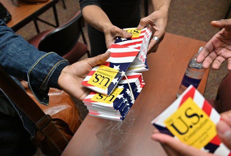 Students receive U.S. Constitution handbooks during Adrienne Jones’ constitutional law class at Morehouse College on Tuesday, Feb. 8, 2022. (Hyosub Shin / Hyosub.Shin@ajc.com)