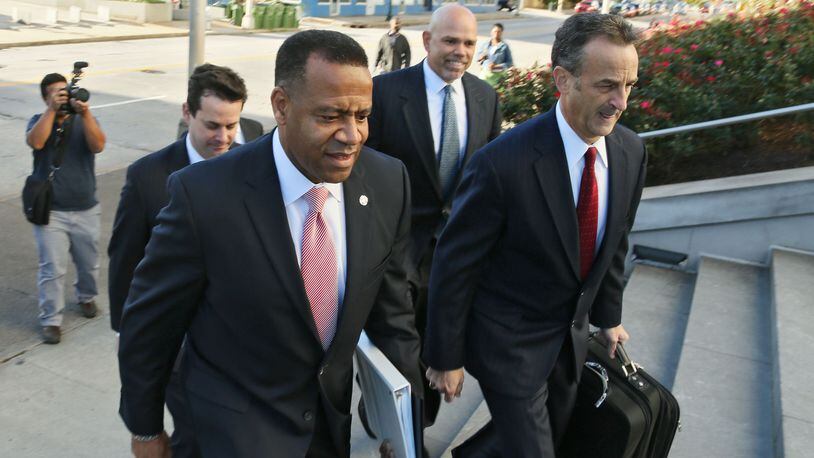 Former Atlanta Fire Chief Kelvin Cochran (left) arrives at federal court for a hearing over his wrongful-termination lawsuit against Atlanta, Oct. 14. (AJC Photo / Bob Andres)