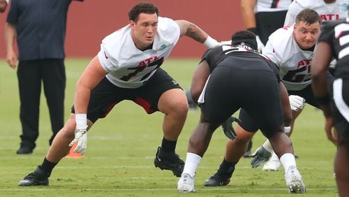073021 Flowery Branch: Atlanta Falcons offensive lineman Jalen Mayfield (left), the team's third round draft pick, gets in some work next to Chris Lindstrom the second day of training camp practice at the team training facility on Friday, July 30, 2021, in Flowery Branch.   “Curtis Compton / Curtis.Compton@ajc.com”