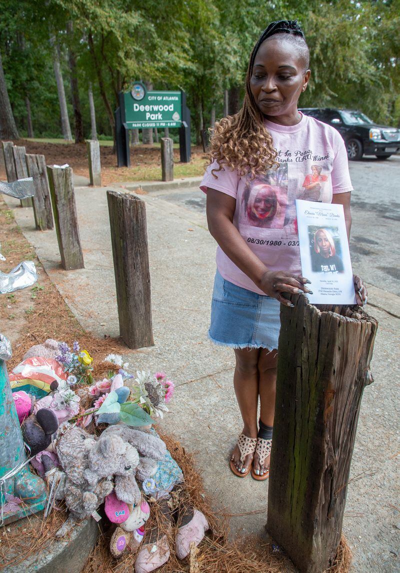 Mildred Barnett, the mother of Elexcia Banks, stands next to a memorial for her daughter, who was shot and killed in Deerborn Park on March 26 in Atlanta. STEVE SCHAEFER FOR THE ATLANTA JOURNAL-CONSTITUTION STEVE SCHAEFER FOR THE ATLANTA JOURNAL-CONSTITUTION