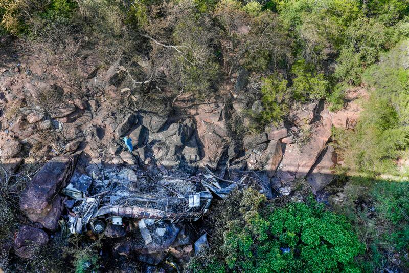 The wreckage off a bus lays in a ravine a day after it plunged off a bridge on the Mmamatlakala mountain pass between Mokopane and Marken, around 300km (190 miles) north of Johannesburg, South Africa, Friday, March 29, 2024. A bus carrying worshippers on a long-distance trip from Botswana to an Easter weekend church gathering in South Africa plunged off a bridge on a mountain pass Thursday and burst into flames as it hit the rocky ground below, killing at least 45 people, authorities said. The only survivor was an 8-year-old child who was receiving medical attention for serious injuries. (AP Photo/Themba Hadebe)
