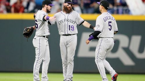 The Rockies did a lot of celebrating at SunTrust Park. Left to right: David Dahl Charlie Blackmon and Carlos Gonzalez.