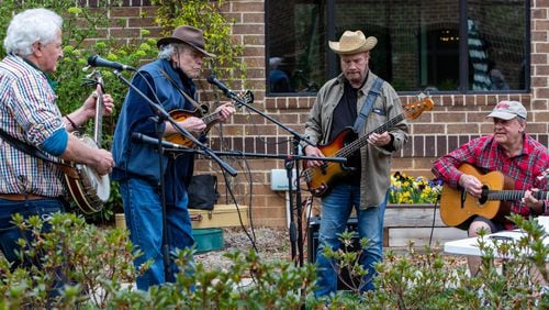 The Druid Hills Billys, Paul Parker (from left), Jim Culliton, Dave Cooper and Skip Romaner, perform at Clairmont Place in Decatur. The band, made up of physicians in the area, which regularly played at Clairmont Place before the pandemic, kept it up and increased performances during the lockdown. They played outdoors with residents listening from their balconies. PHIL SKINNER FOR THE ATLANTA JOURNAL-CONSTITUTION.