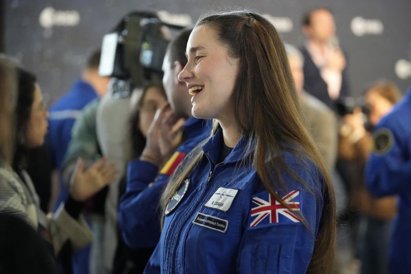 Astronaut Rosemary Coogan of Britain smiles during the candidates of the Class of 2022 graduation ceremony at the European Astronaut Centre in Cologne, Germany, Monday, April 22, 2024. ESA astronaut candidates Sophie Adenot of France, Pablo Alvarez Fernandez of Spain, Rosemary Coogan of Britain, Raphael Liegeois of Belgium and Marco Sieber of Switzerland took up duty at the European Astronaut Centre one year ago to be trained to the highest level of standards as specified by the International Space Station partners. Also concluding a year of astronaut basic training is Australian astronaut candidate Katherine Bennell-Pegg, who has trained alongside ESA's candidates. (AP Photo/Martin Meissner)