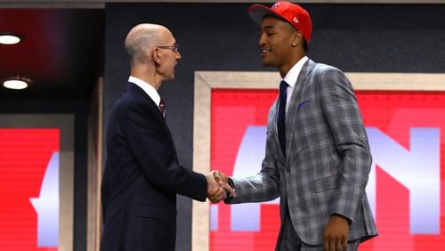John Collins walks on stage with NBA commissioner Adam Silver after being drafted 19th overall by the Atlanta Hawks during the first round of the 2017 NBA Draft at Barclays Center on June 22, 2017 in New York City. (Photo by Mike Stobe/Getty Images)