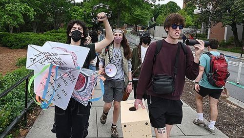 Pro-Palestinian protesters chant as they walk to Tate Plaza to continue their protest on University of Georgia campus, Tuesday, April 30, 2024, in Athens.  (Hyosub Shin / AJC)