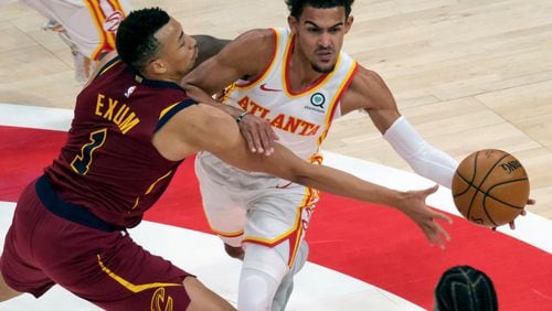 Atlanta Hawks guard Trae Young (11) is fouled by Cleveland Cavaliers guard Dante Exum (1) during the first half of an NBA basketball game on Saturday, Jan. 2, 2021 in Atlanta. (AP Photo/Ben Gray)