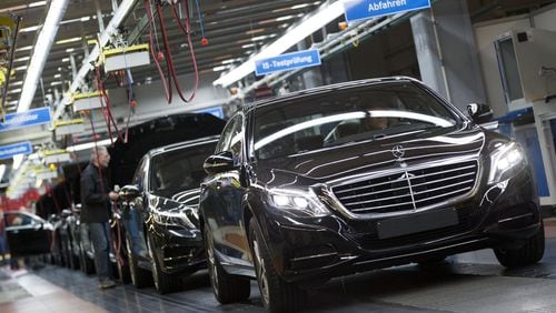 In this Jan. 28, 2015 file photo, a Mercedes-Benz AG employee checks a S-Class model at the plant in Sindelfingen, Germany. The S-Class is among the vehicles included in a potential class-action lawsuit against the automaker for climate control systems that emit a foul odor. (AP Photo/Matthias Schrader, File)