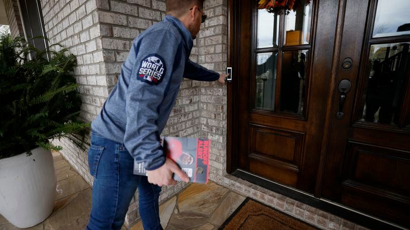 A Herschel Walker campaign staffer rings a door in a Milton subdivision to encourage supporters to vote. Thousands of campaign staffers and volunteers are hitting the streets to encourage people to vote in the state's U.S. Senate runoff on Dec. 6 between Democratic incumbent Raphael Warnock and Republican challenger Herschel Walker. Miguel Martinez / miguel.martinezjimenez@ajc.com
