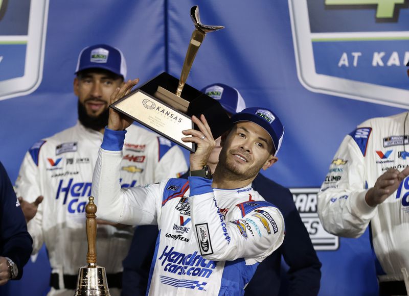 Kyle Larson, center, celebrates in Victory Lane after winning a NASCAR Cup Series auto race at Kansas Speedway in Kansas City, Kan., Sunday, May 5, 2024. (AP Photo/Colin E. Braley)
