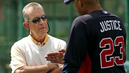 Braves president John Schulhotz, left, talks with former Brave David Justice in spring training in 2012, more than 15 years after Schuerholz traded to Justice to Cleveland. Jason Getz / AJC file