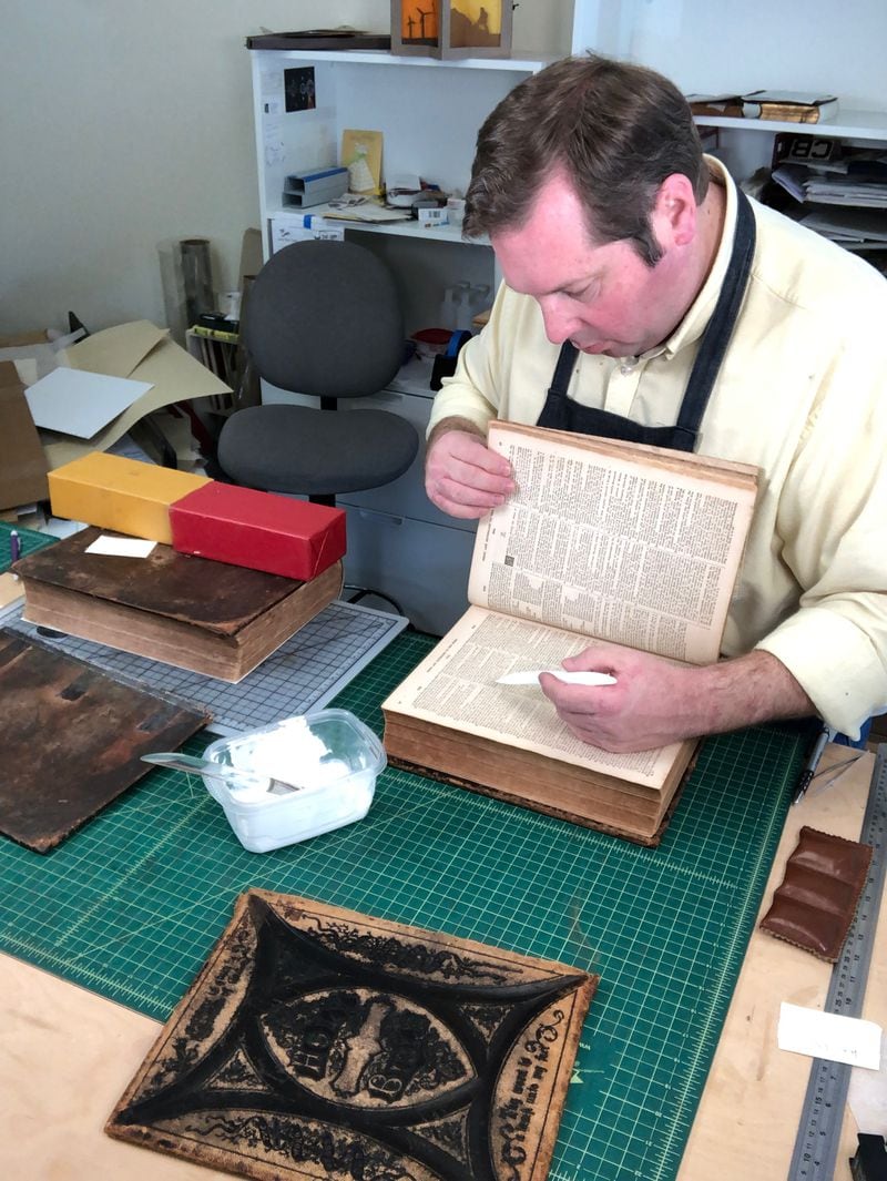 Andrew Huot, owner of Big River Bindery in Stone Mountain, takes his time to ensure his book restoration is perfect. Courtesy of Andrew Huot