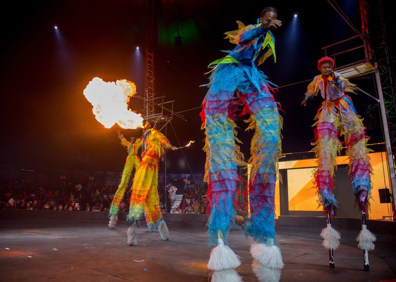 Performers walk around the rink on stilts breathing fire during a Sunday afternoon show of the UniverSoul Circus in Atlanta. CONTRIBUTED BY STEVE SCHAEFER