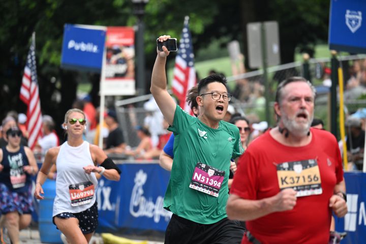 Runner celebrates at the finish of the 54th running of the Atlanta Journal-Constitution Peachtree Road Race in Atlanta on Tuesday, July 4, 2023.   (Hyosub Shin / Hyosub.Shin@ajc.com)