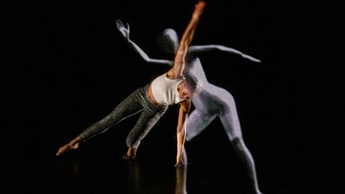 Cymone Jeter, a student in Kennesaw State University's Dance Department, with the LuminAI avatar, part of a recent performance and discussion at KSU’s Dance Theater in Marietta.