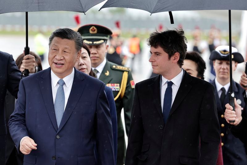 Chinese President Xi Jinping is welcomed by French Prime Minister Gabriel Attal at Orly airport, south of Paris, Sunday, May 5, 2024. Chinese President Xi Jinping kicked off a three-country trip to Europe on Sunday with the continent divided over how to deal with Beijing's growing power and the U.S.-China rivalry. (Stephane de Sakutin, Pool via AP)