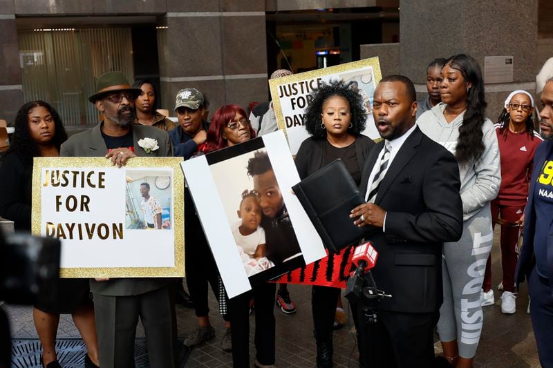 Attorney Michael Harper holds a photo of Dayvion Blake and his daughter as he answers questions to the media during a press conference at the Fulton County Government Center demanding justice after he died at the Fulton County Jail after being stabbed on August 31, 2023.
Miguel Martinez /miguel.martinezjimenez@ajc.com