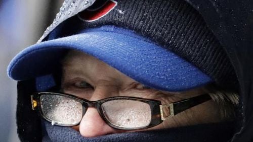 A Cubs fan bundled up for Saturday’s game at Wrigley Field. (AP photo)